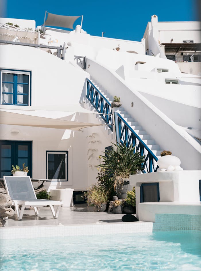 about-01 Explore the iconic white architecture and poolside luxury in Santorini, Greece.