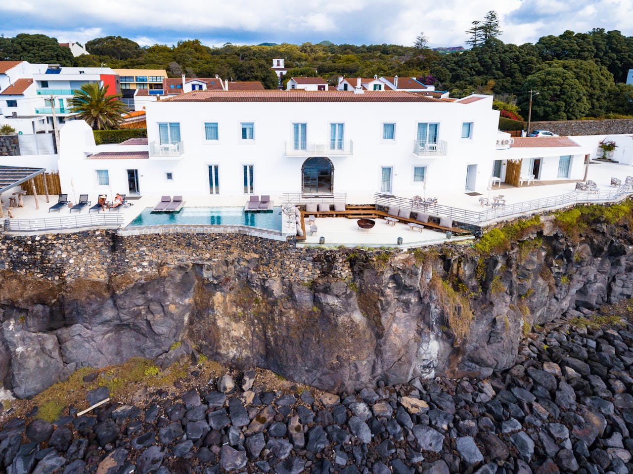 our-services-2 Stunning white villa on a cliffside with pool overlooking the sea in the Azores.